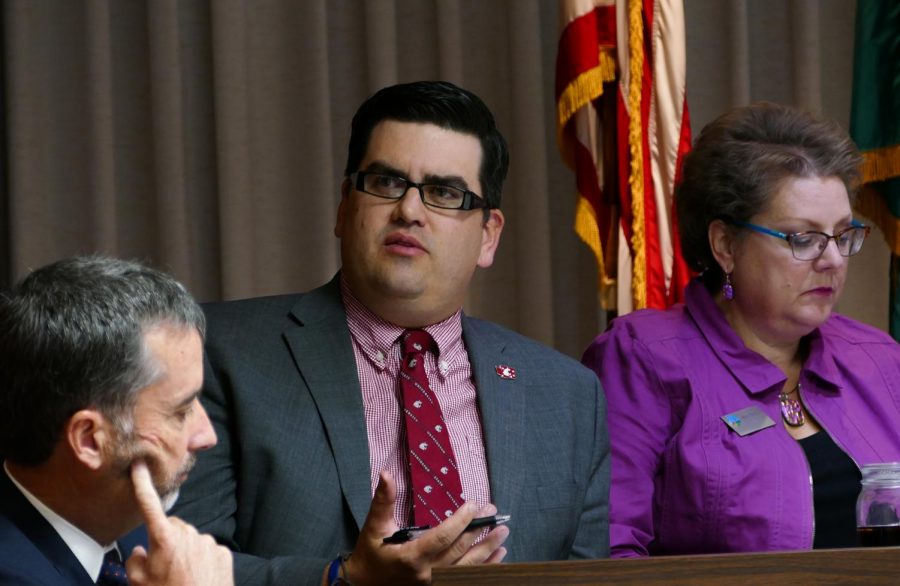 Councilmember Brandon Chapman, center, asks questions during the meeting Tuesday.