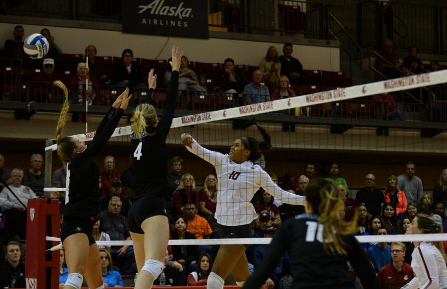 Then-junior outside hitter Taylor Mims spikes the ball past a pair of Colorado defenders Oct. 6 at Bohler Gym.
