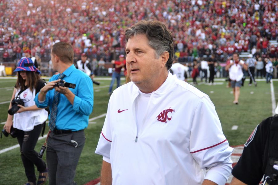 WSU Head Coach Mike Leach runs out onto the field with his team before the game against University of Oregon on Saturday at Martin Stadium. 