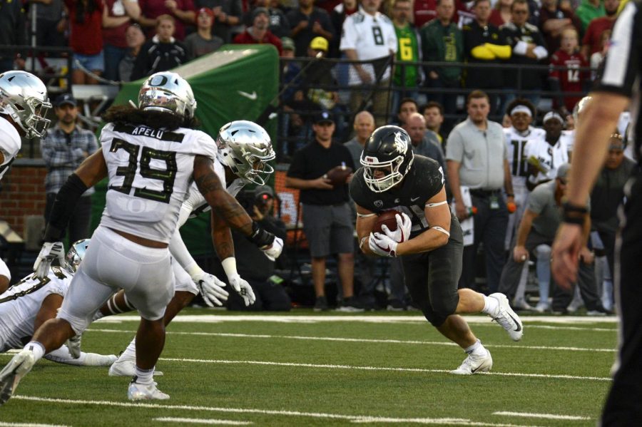Freshman running back Max Borghi holds tightly to the ball as he attempts to rush into the endzone during the game against University of Oregon on Oct. 20 at Martin Stadium.