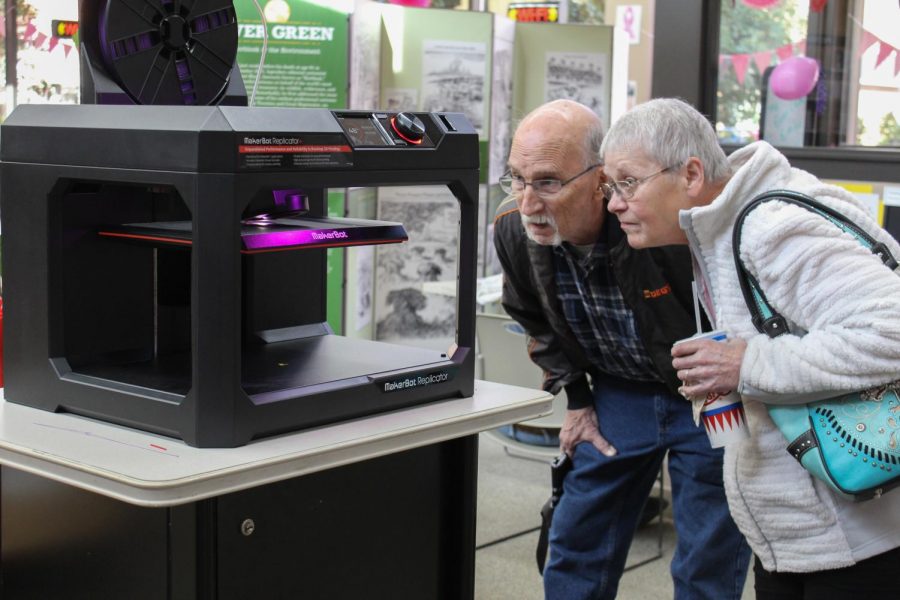 Two seniors examine the MakerBot Replicator+ at the Colfax library branch. “I felt like the older people were really intrigued with it,” Director Kristie Kirkpatrick said.