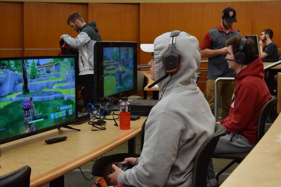 Teammates Daniel Brents, left, and Ben Bledsoe, right, gather materials in Fortnite during the esports competition Sunday in the CUE.
