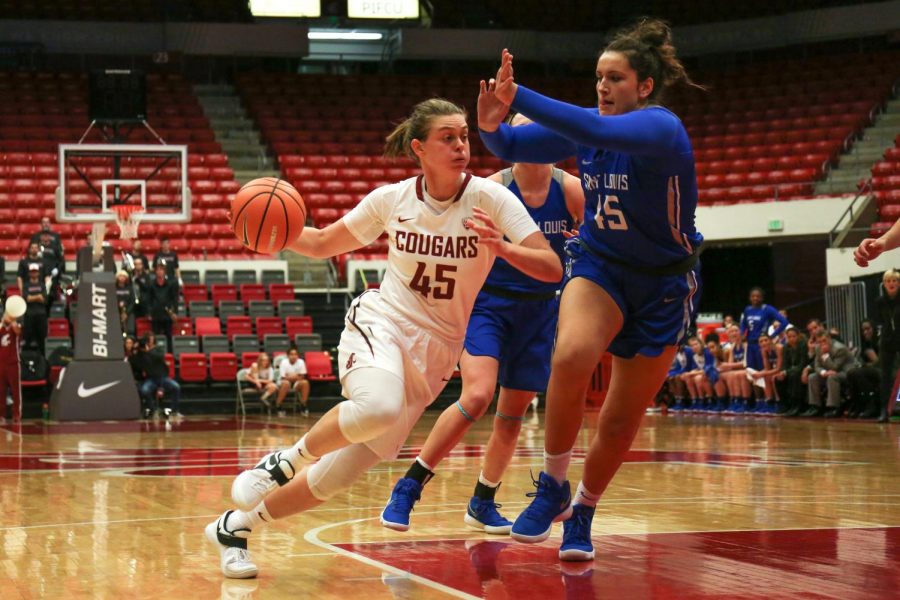 Redshirt sophomore Borislava Hristova drives to the hoop and gets past Saint Louis University’s then-junior center Tara Dusharm and adds two points to the WSU win Dec. 4 in Beasley Coliseum.