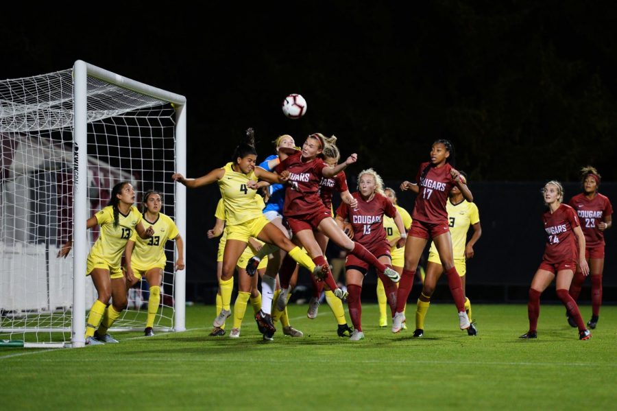 Redshirt junior forward Alysha Overland attempts to score a header off of a corner kick during the game against the university of Oregon on Thursday at the lower soccer fields.