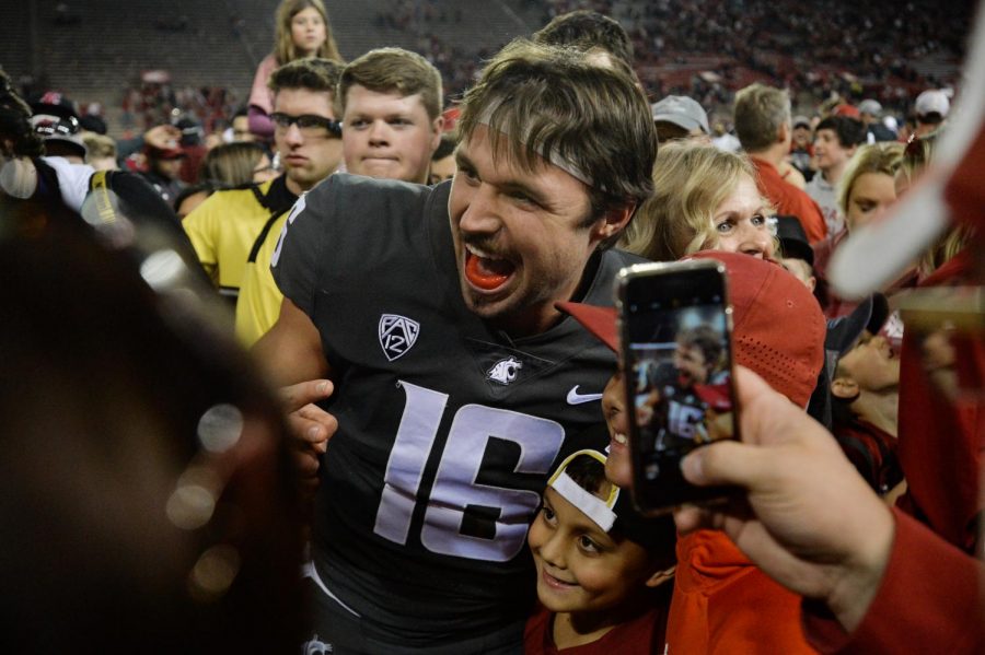 Quarterback Gardner Minshew II poses with celebrating fans after the game against University of Oregon on Oct. 20 at Martin Stadium. Minshew currently leads the nation in passing with 3,183 yards and 26 passing touchdowns. 