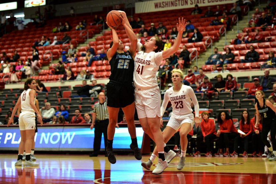Redshirt sophomore forward Jovana Subasic blocks a shot from Warner Pacific senior forward Maryah Tipping, drawing the foul near the end of the second quarter Monday evening in Beasley Coliseum.