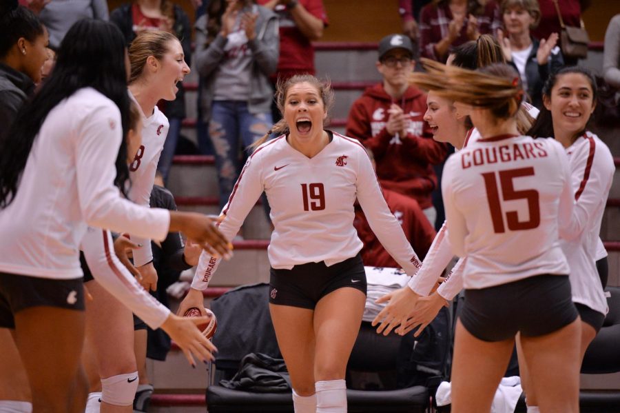 Junior+setter+Ashley+Brown+high-fives+her+teammates+during+the+introduction+of+the+starting+lineup+before+the+game+against+University+of+California%2C+Los+Angeles%2C+on+Oct.+21+in+Bohler+Gym.