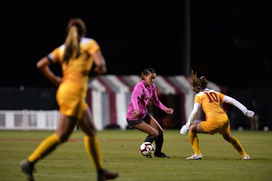 Sophomore forward Makamae Gomera-Stevens dodges a defender in the game against USC Saturday night at the Lower Soccer Field.