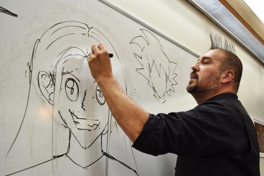 Renowned artist Carlos Nieto III teaches a group of youngsters around ages 11 to 15 how to create their very own stylized anime characters Monday evening in the Neill Public Library.