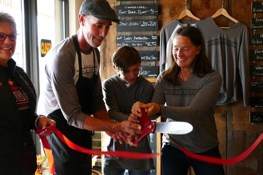 3 Forks Bike And Brew founders Scott McBeath, left, and Francene Watson, right, cut the ribbon opening their restaurant on Thursday night.