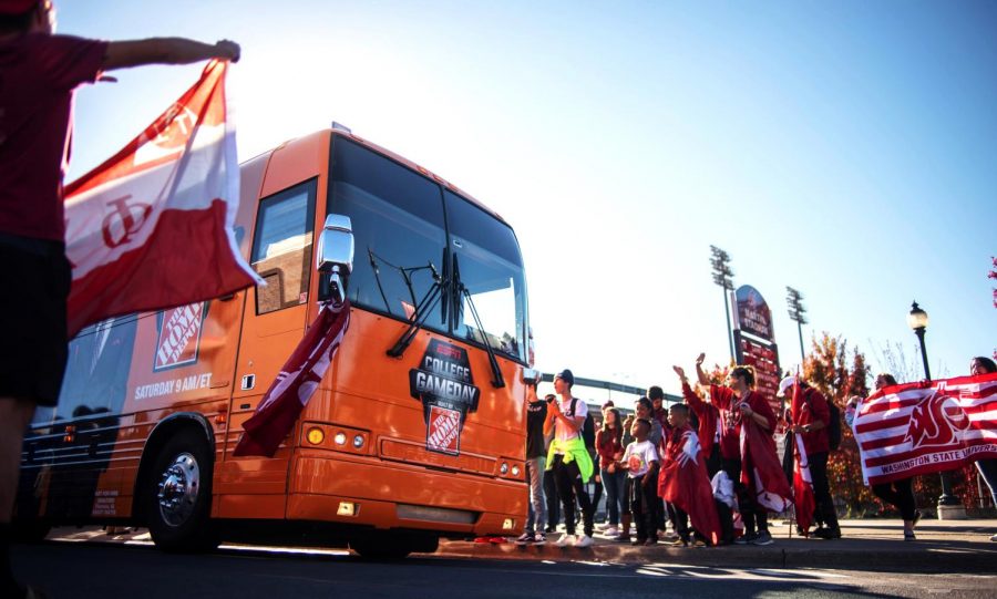 Coug fans cheer as ESPN’s College GameDay arrives in Pullman on Wednesday in front of Martin Stadium.