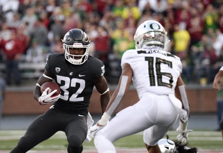 Redshirt junior running back James Williams evades a series of defensive tackles during the game against University of Oregon on Saturday night at Martin Stadium. Williams broke eight tackles and rushed 24 yards to score WSU’s first touchdown.