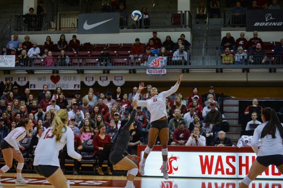 Senior outside hitter Taylor Mims jumps to hit a set made by junior setter Ashley Brown during the match against Washington on Saturday in Bohler Gym. This is the team’s third consecutive year making it to the NCAA Tournament.