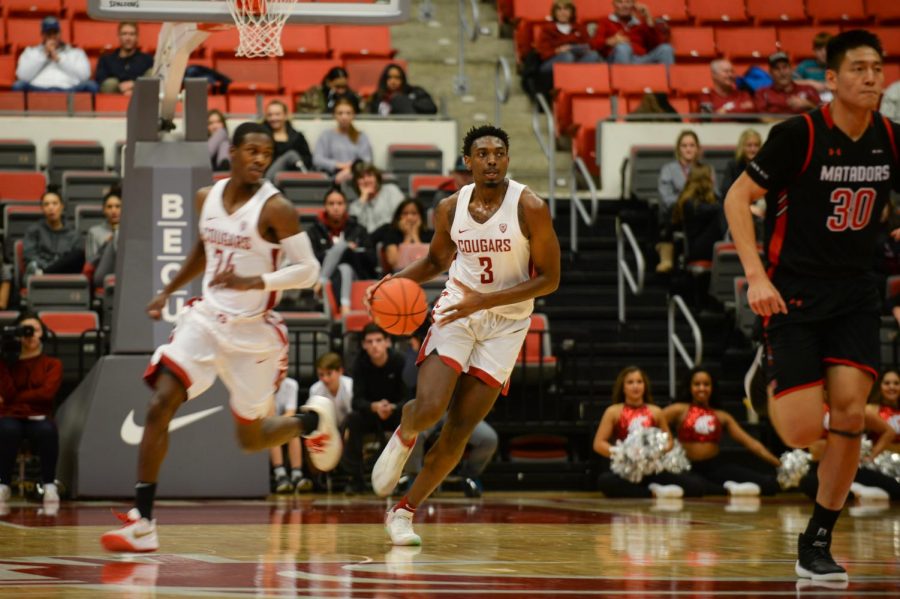 Senior forward Robert Franks dribbles down court as he looks to pass to junior point guard Ahmed Ali during the game against California State University Northridge on Nov. 27 at Beasley Coliseum.