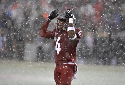 Junior cornerback Marcus Strong attempts to rally WSU fans during the first half of the Apple Cup on Friday night at Martin Stadium. The Cougars lost 28-15.