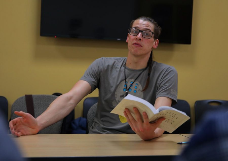 Joseph Ostheller, president of the World Peace Buddhist Club, reads out of “The Heart of the Lotus Sutra” during the club’s weekly meeting Wednesday in the CUB. The club hopes to bring meaning to students’ daily activities.