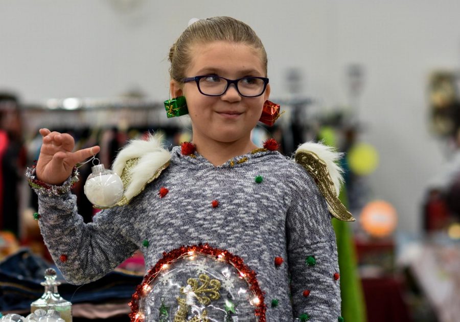 Jordan Lusby, 8-year-old slime maker and the youngest Mrs. Claus’ Holiday Bazaar seller, discusses her business Saturday at the Latah County Fair and Event Center.