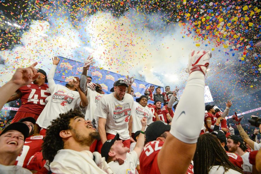 The WSU football team celebrates after their 28-26 win over Iowa State University on Friday night at the Alamo Bowl in San Antonio, Texas. The Cougars end their season 11-2.
