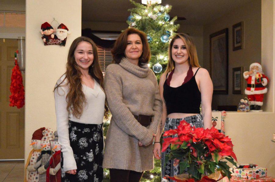 Managing editor Sydney Brown, right, poses with her mother Sally Miller, center, and her sister Alex Brown, left, at their home in Las Vegas, Nevada on Christmas Eve.