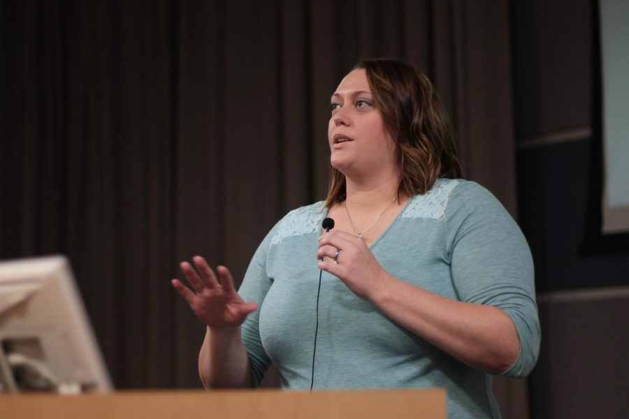 Lauren Wells, chair of the WSU commission on the status of women, speaks about the goals of the commission and what it has already accomplished at the Faculty Senate meeting Thursday.
