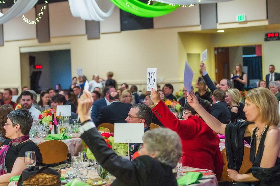 Attendees of last year’s Pullman Regional Hospital Foundation Gala hold up auction numbers looking to donate money to the hospital.