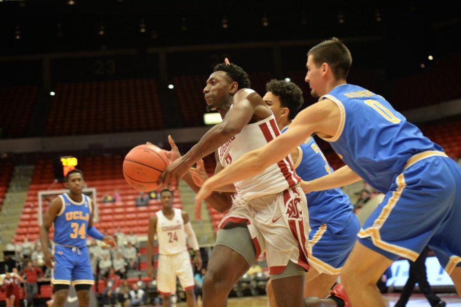 Senior forward Robert Franks fights through two UCLA defenders during a game Wednesday night at Beasley Coliseum.