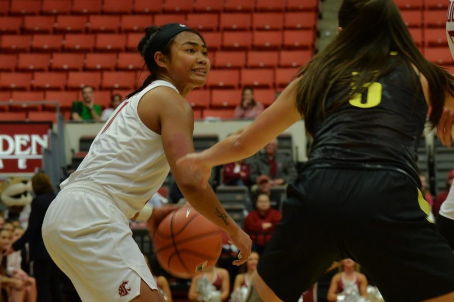 WSU junior guard Chanelle Molina looks towards the basket while an Oregon defender guards her in a game Friday night at Beasley Coliseum. 