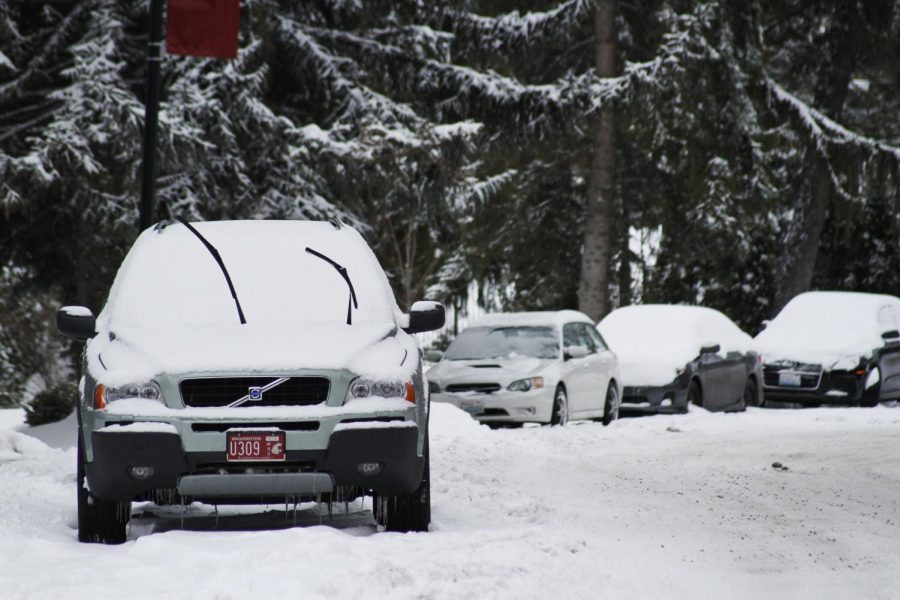 Snow covers vehicles parked along Greek Row in January 2017.