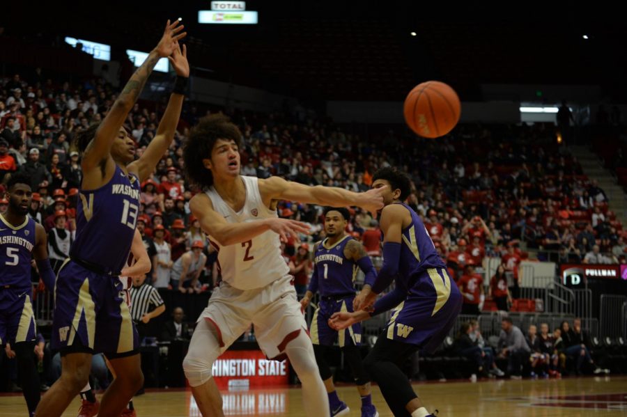 Freshman+forward+CJ+Elleby+makes+a+pass+during+the+game+against+the+Huskies+on+Saturday+night+at+Beasley+Coliseum.+The+game+resulted+in+a+72-70+loss+for+the+Cougars.