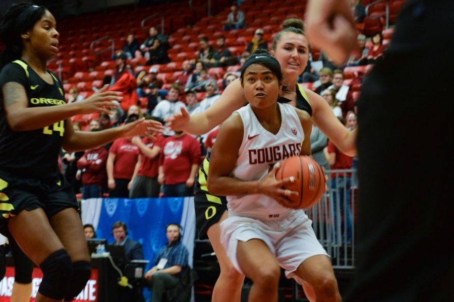 WSU junior guard, Chanelle Molina, center, looks toward the basket as she is approached by Oregon junior forward, Ruthy Hebard, left, U of O red-shirt sophomore forward, Erin Boley, during the game on Friday night at Beasley Coliseum. Cougs lost 64-79.  