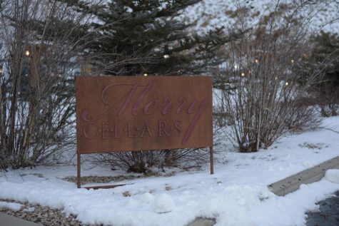 A sign advertising the entrance to the local winery stands among snow Thursday outside Merry Cellars Winery.