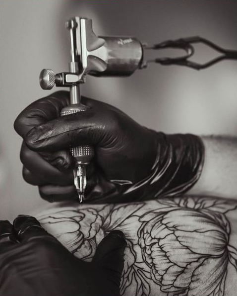 Thad Froio, owner and tattoo artist at Harry and Lloyd’s, specializes in tattooing photo realistic greyscale images.