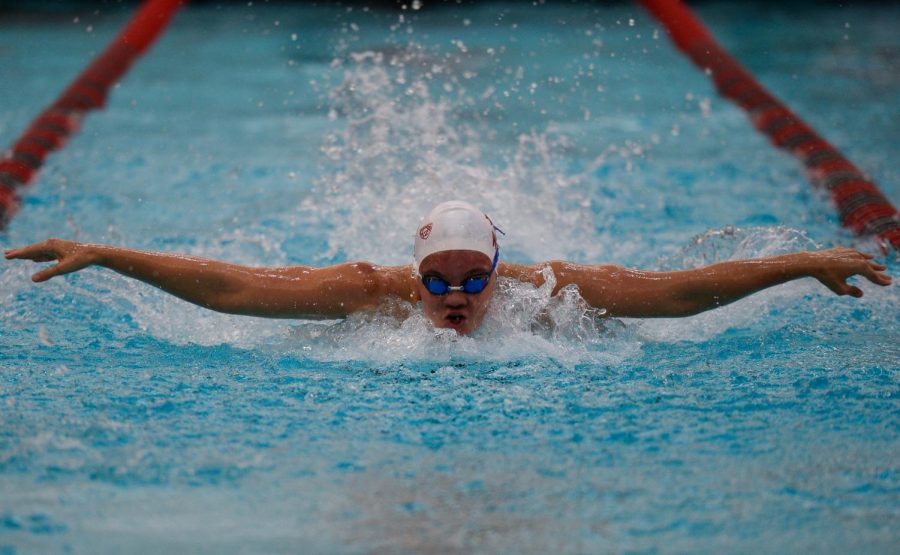 Sophomore freestyle swimmer Sophie Larson competes in the 100-meter fly race during the dual against Utah on Feb. 16 at Gibb Pool. Tomorrow the team competes in the second day of the four-day tournament.