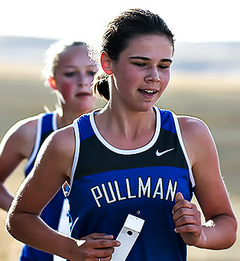 Kylie Franklin, Pullman High School student, races in front of Nicole Jones, PHS student, during a cross-country meet.