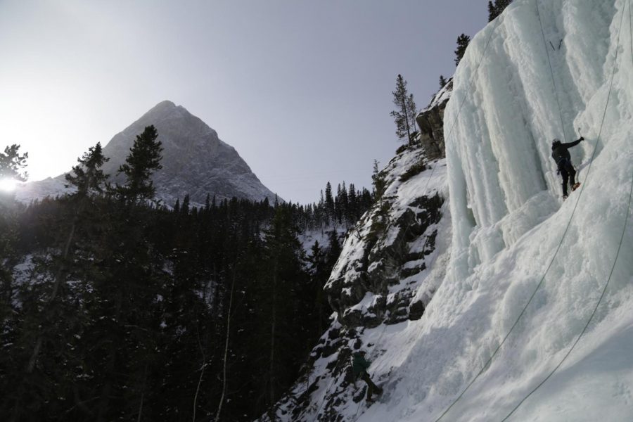 Jonathan Jay Mills, bottom, owner of Canadian Rockies Alpine Guides, is lowered from the ice sheet after setting up a new route Saturday at the Canmore Junkyards in Alberta, Canada.