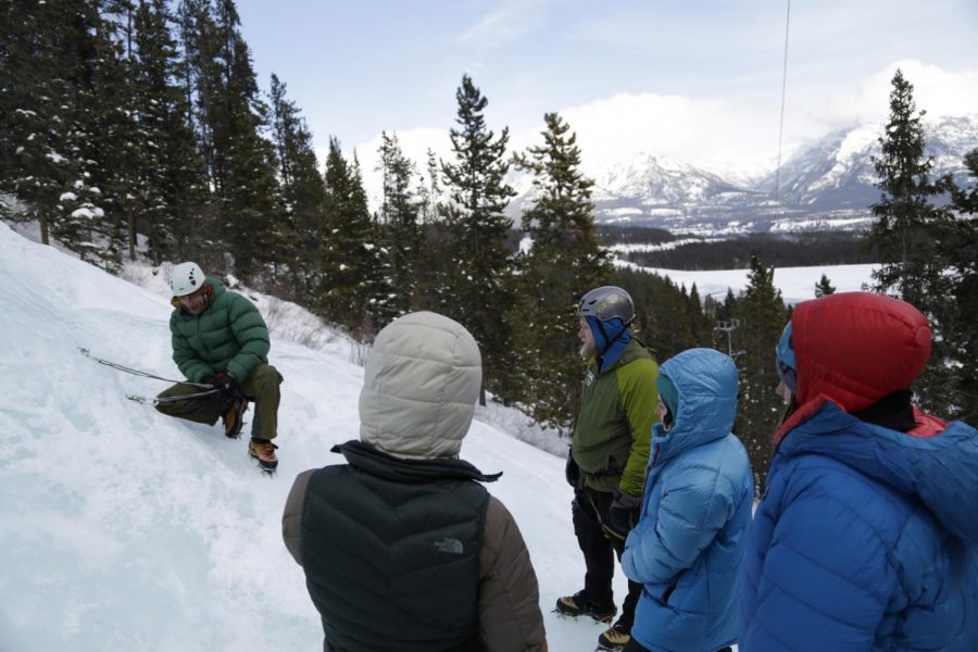 Jonathan Jay Mills, left, owner of Canadian Rockies Alpine Guides, teaches the group on how to properly build a safe anchor point when ice climbing Saturday at the Canmore Junkyards in Alberta, Canada.