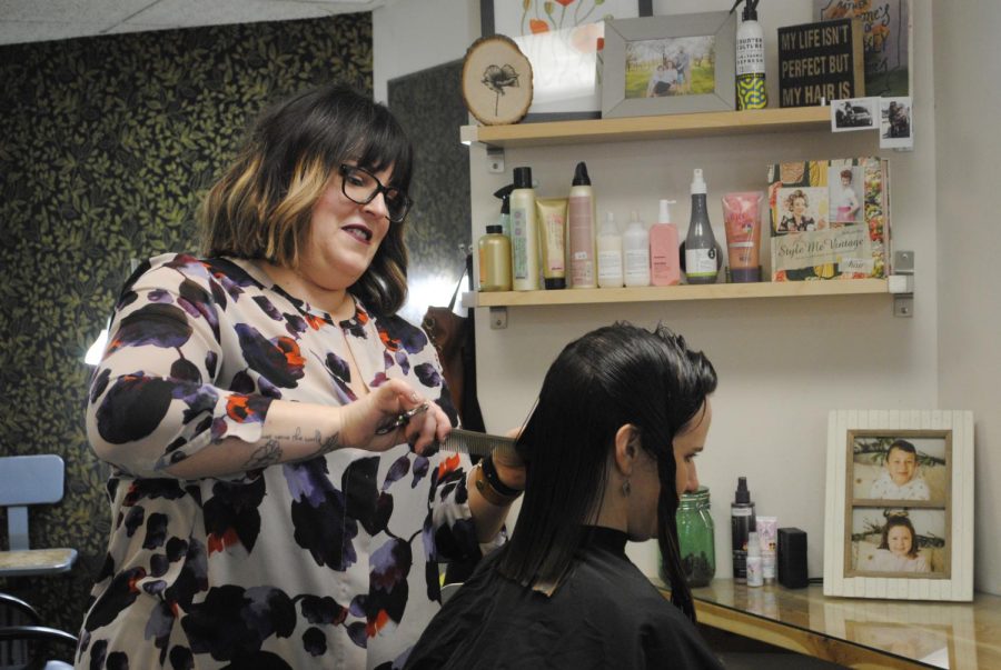 Chelsea Whitney, owner of Poppy Salon and Spa, talks about her business as she works on client Kristin Hansen’s hair on March 21 at Poppy Salon and Spa. The supportive atmosphere at the salon is evident to clients. 