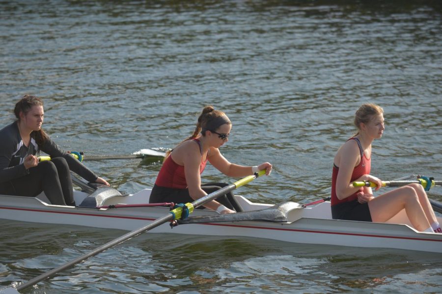 Sophomore Madison Williams, left, senior Rachael Christman, center, and sophomore Taylor Blevins participate in the WSU small boat regatta on Sep. 29 at Wawawai Landing.