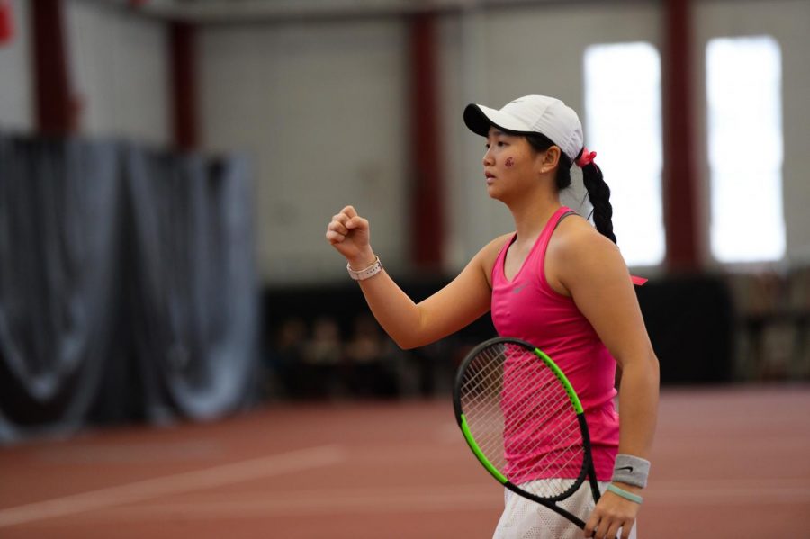 Freshman Yang Lee celebrates a point scored during doubles play against BYU on Feb. 22 in Hollingbery Fieldhouse. 