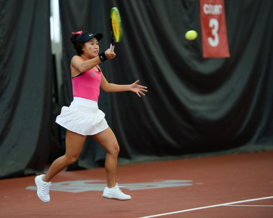 WSU Freshman Savanna Ly-Nguyen returns a ball during singles play against BYU Feb. 22 in Hollingbery Fieldhouse. Ly-Nguyen won her match in straight sets.