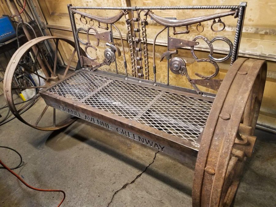 A local artist is in the process of completing this bench that will soon be used by Neill Public Li-brary visitors. The artwork is intended to honor the Ingleside club for their establishment over one hundred years ago.