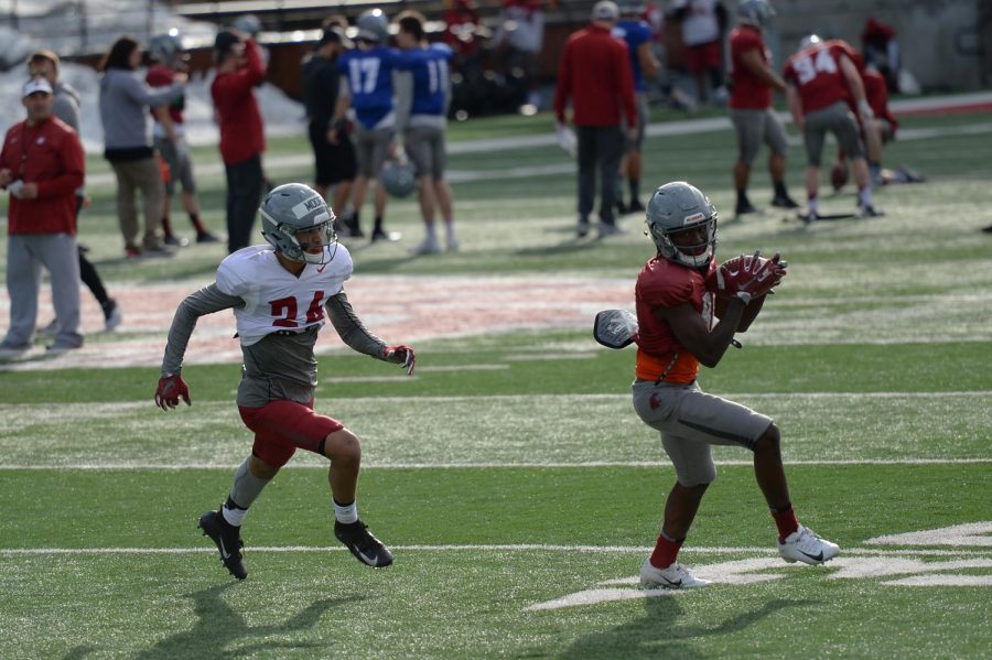 Redshirt junior wide receiver Renard Bell, right, heads downfield as Shahman Moore, redshirt junior defensive back, chases after him during spring practice on Mar. 26 at Martin Stadium.