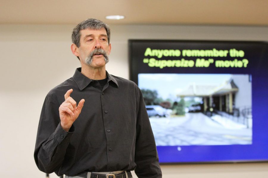 Mark Fenton, a public health, planning, and transportation consultant, discusses possible changes to Pullman roads that could make it safer for pedestrians, bikers, buses and cars Thursday at the Chinook Student Center. 