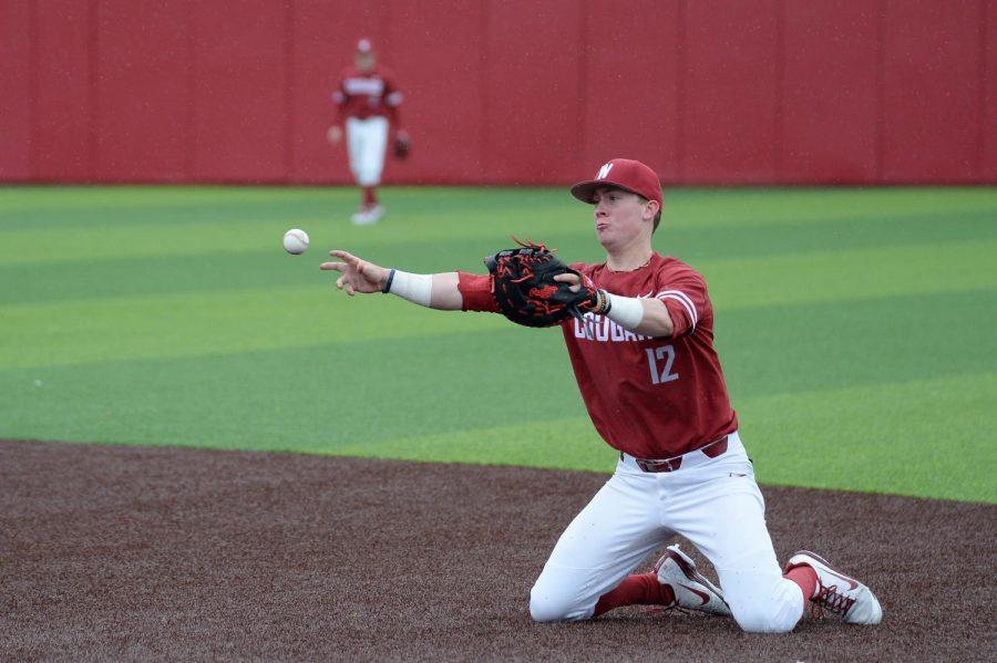 Sophomore first baseman Jack Smith throws the ball to first to force out the runner after diving to block the ball from going to the outfield during game two or the series against Oregon April 13 at Bailey-Brayton Field. 