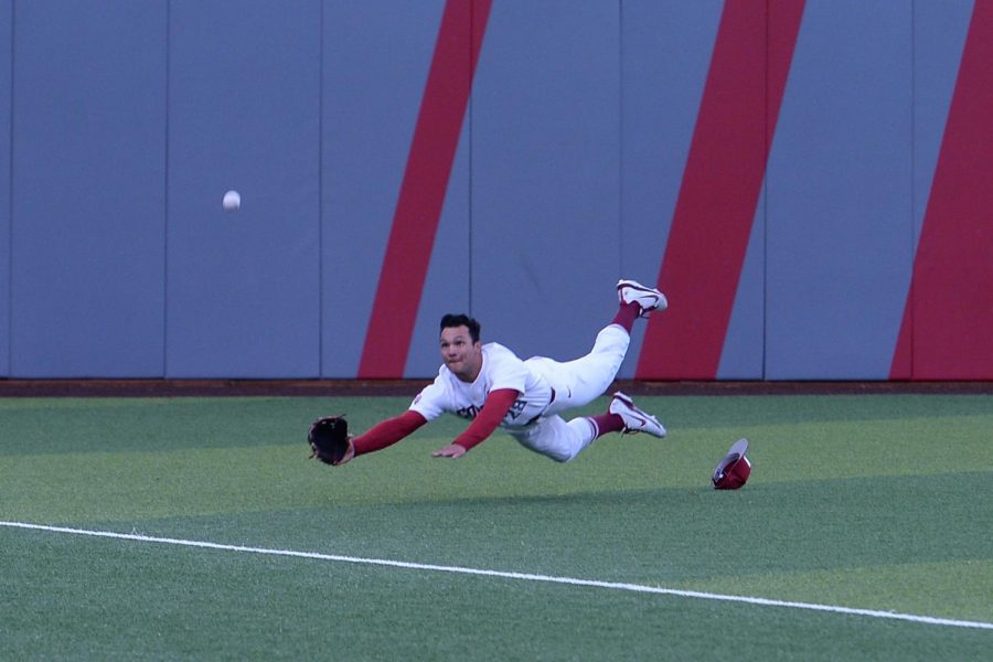 Sophomore outfielder Collin Montez dives to catch the ball during the game against Oregon on Apr. 12 at Bailey-Brayton Field.