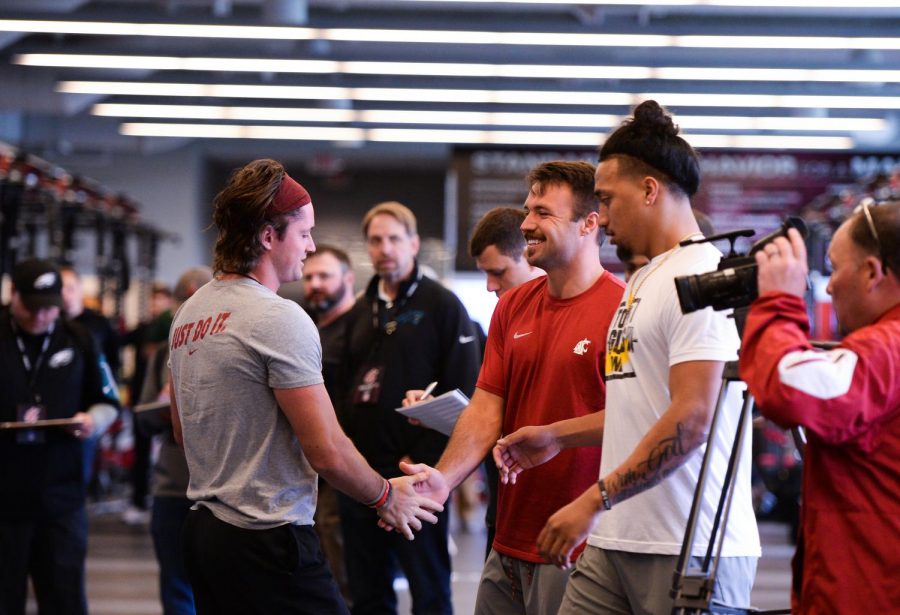 Former quarterback Gardner Minshew II, right, congratulates former wide receiver Kyle Sweet on his performance in the 225-pound bench press during Pro Day on Wednesday at the Cougar Football Complex.