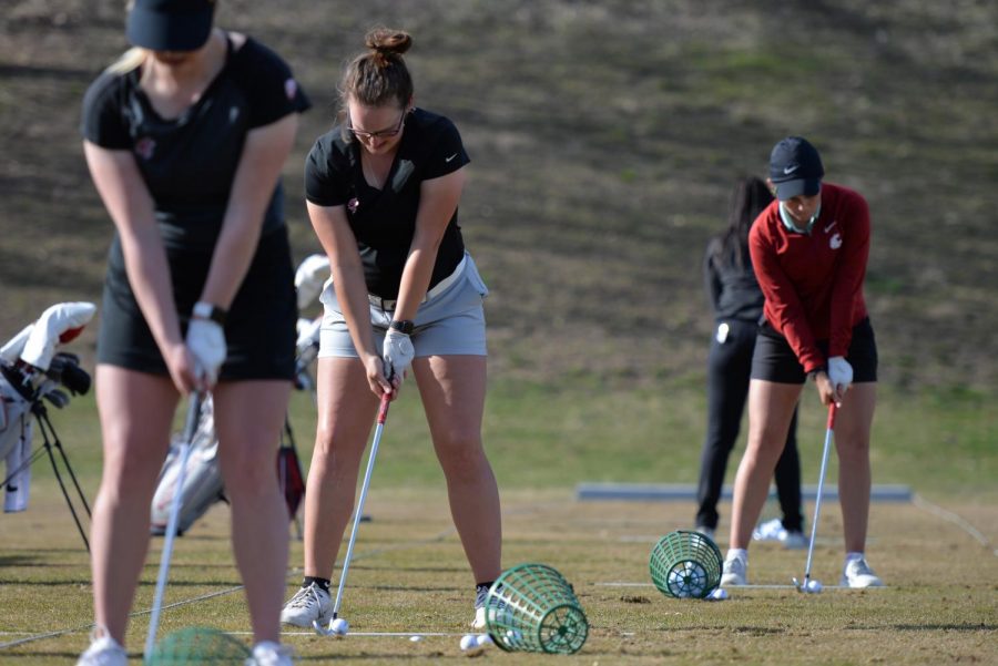 Redshirt sophomore Emily Baumgart sets up  range balls during a practice session Monday afternoon at WSUs practice facility.