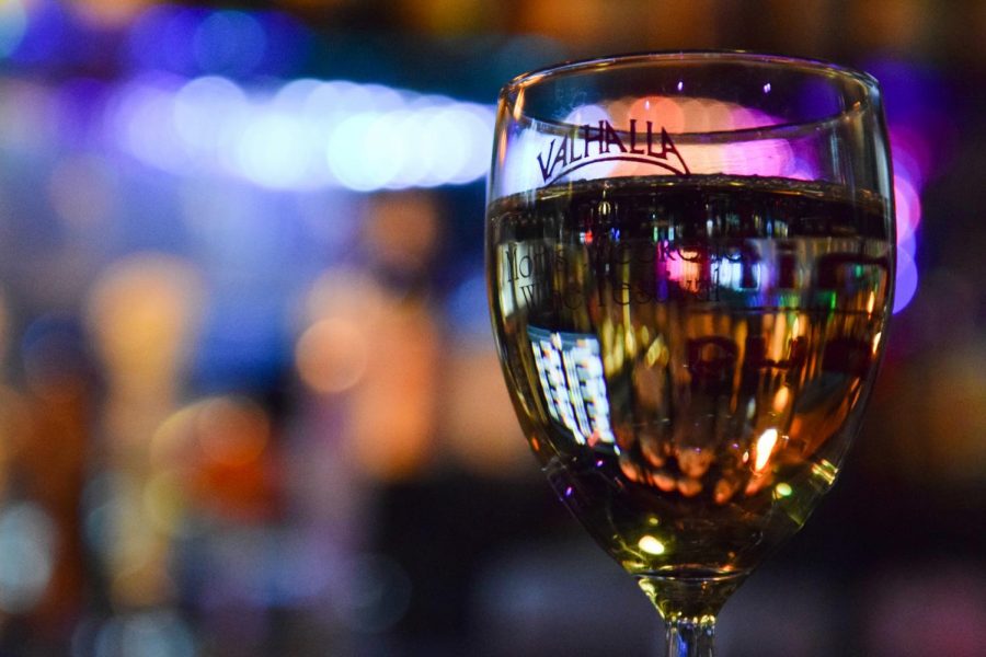 White wine fills a Valhalla Wine Festival glass on Tuesday at Valhalla Bar and Grill. Spenser Peery says the annual Winefest combines several hospitality groups on campus, which helps these students get more experience in their field. 