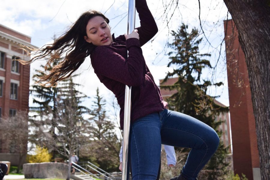 Sophomore psychology major Alyssa Castrillon practices on a pole in preparation for Cabaret Night, an event put on by the Aerial Dance Society, on Wednesday at the Glen Terrell Friendship Mall. Cabaret night will take place on Saturday, April 13 in the Jones Theater. 