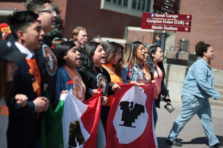 WSU students march up the mall chanting in support of undocumented students 
at WSU as a protest Tuesday afternoon on the Glen Terrell Friendship Mall.